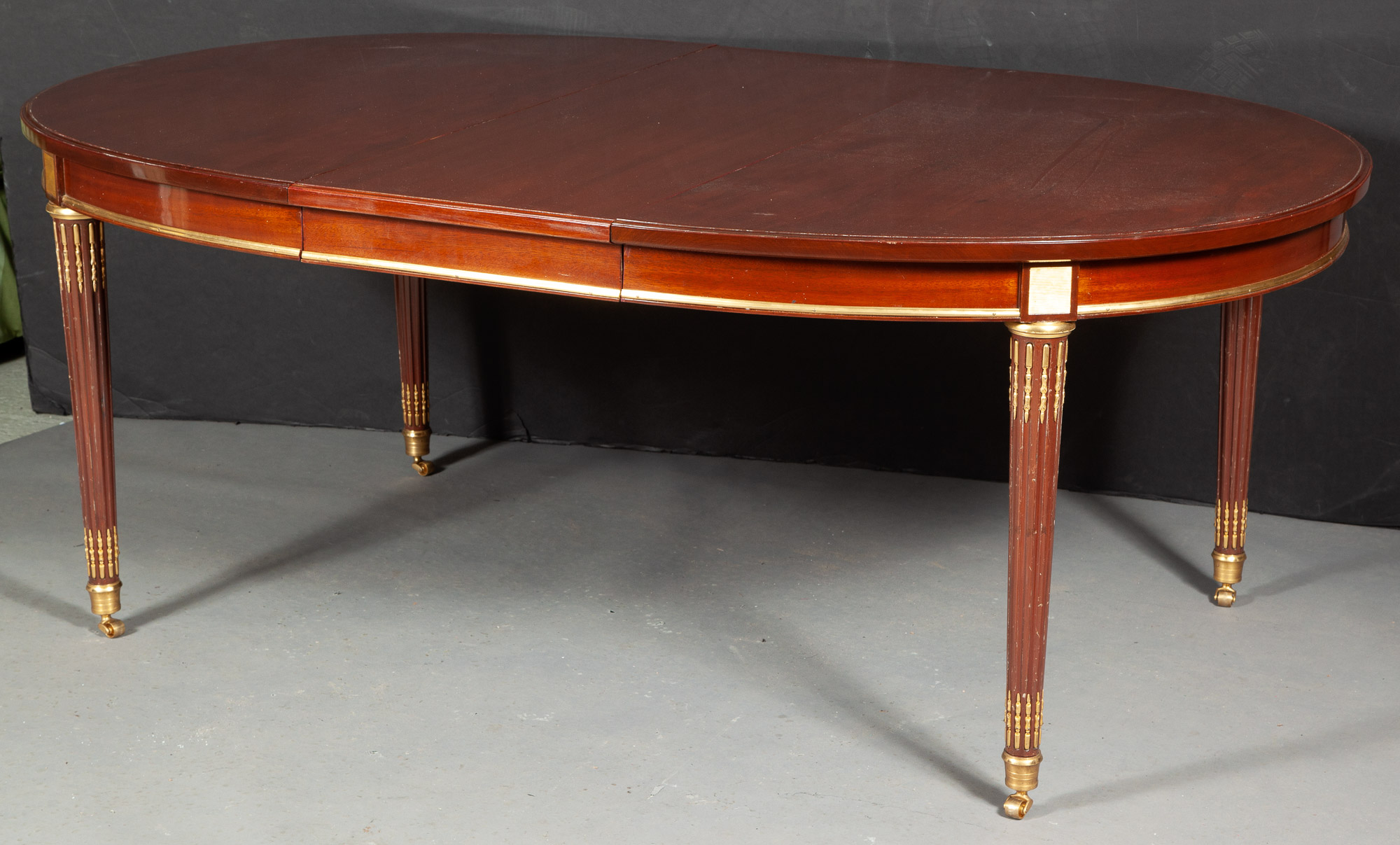 Lot image - Louis XVI Style Gilt-Metal-Mounted Mahogany Extension Dining Table