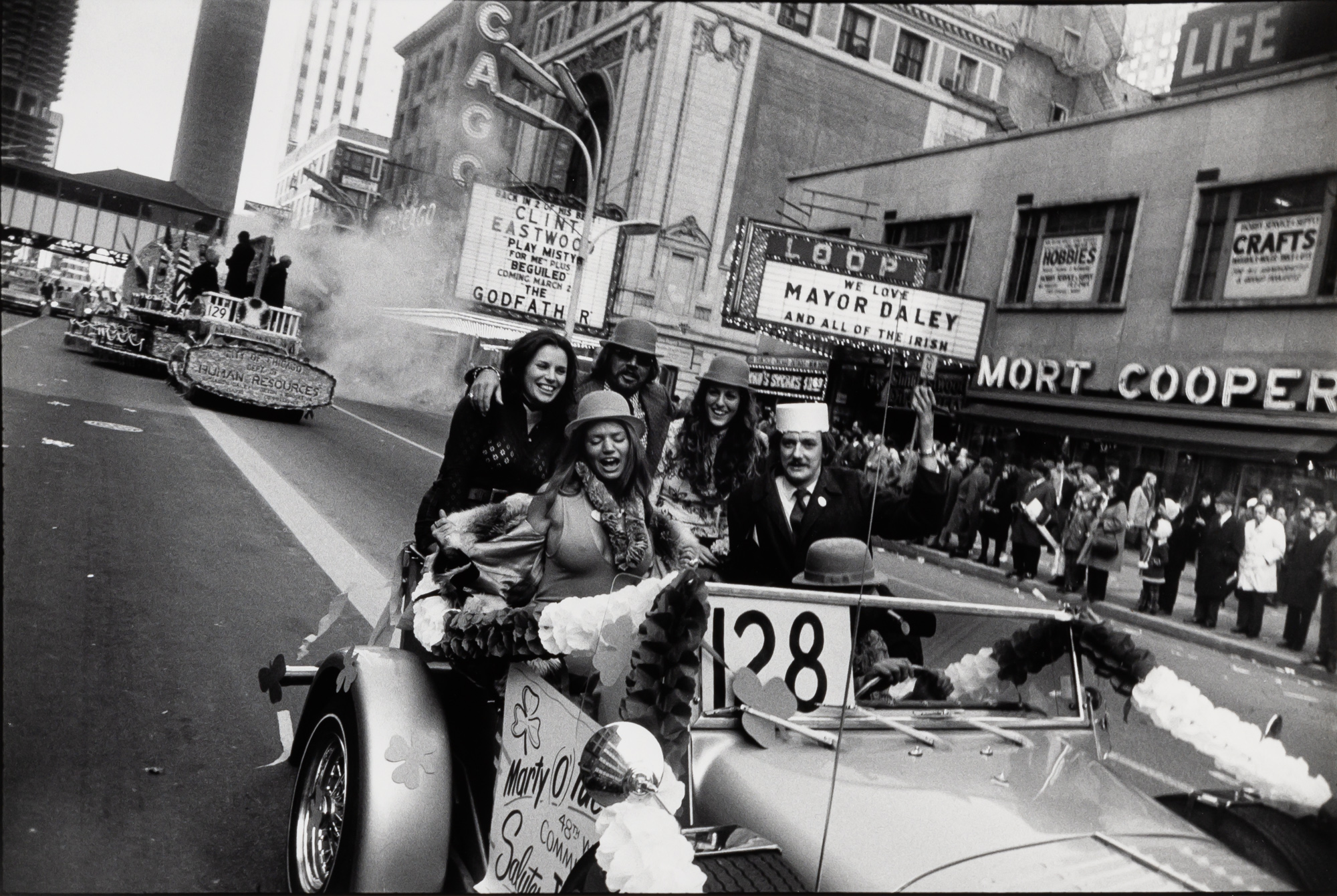 Lot image - WINOGRAND, GARRY (1928-1984)  Untitled [Celebrants in Car, St. Patricks Parade, Chicago],