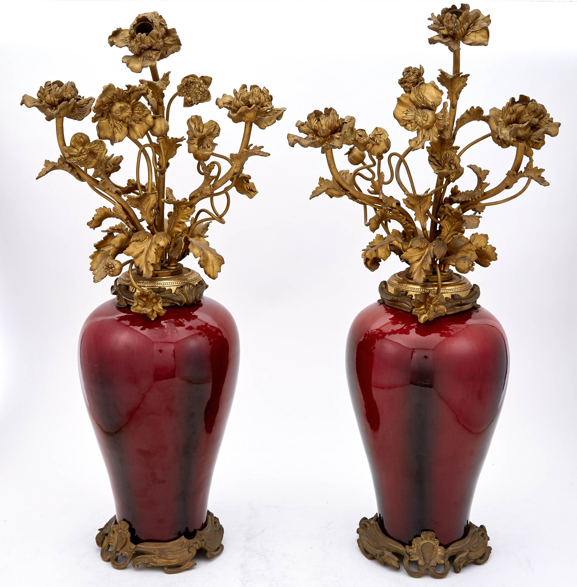Lot image - Pair of Gilt-Bronze Mounted Sang de Boeuf Porcelain Three-Light Lamp