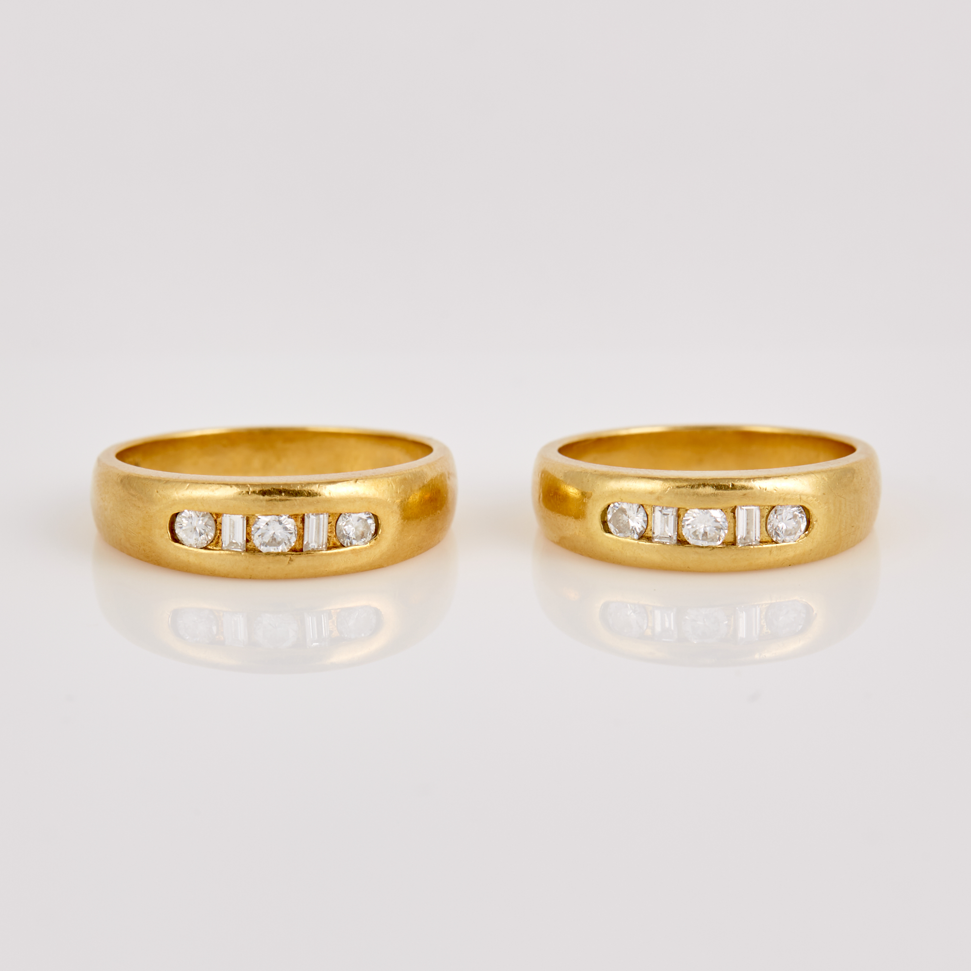 Lot image - Two Diamond Wedding Rings, 10 diamonds about 0.55 ct., 18K 9 dwt.