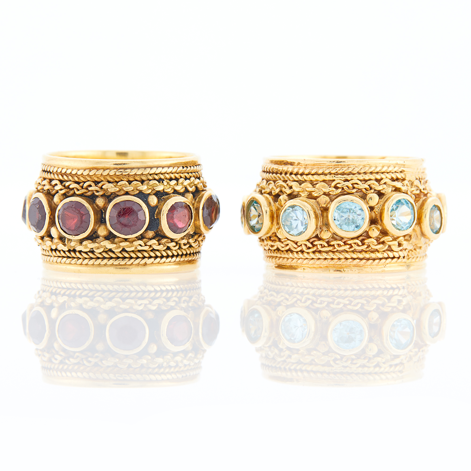 Lot image - Two Wide Gold, Garnet and Blue Topaz Band Rings