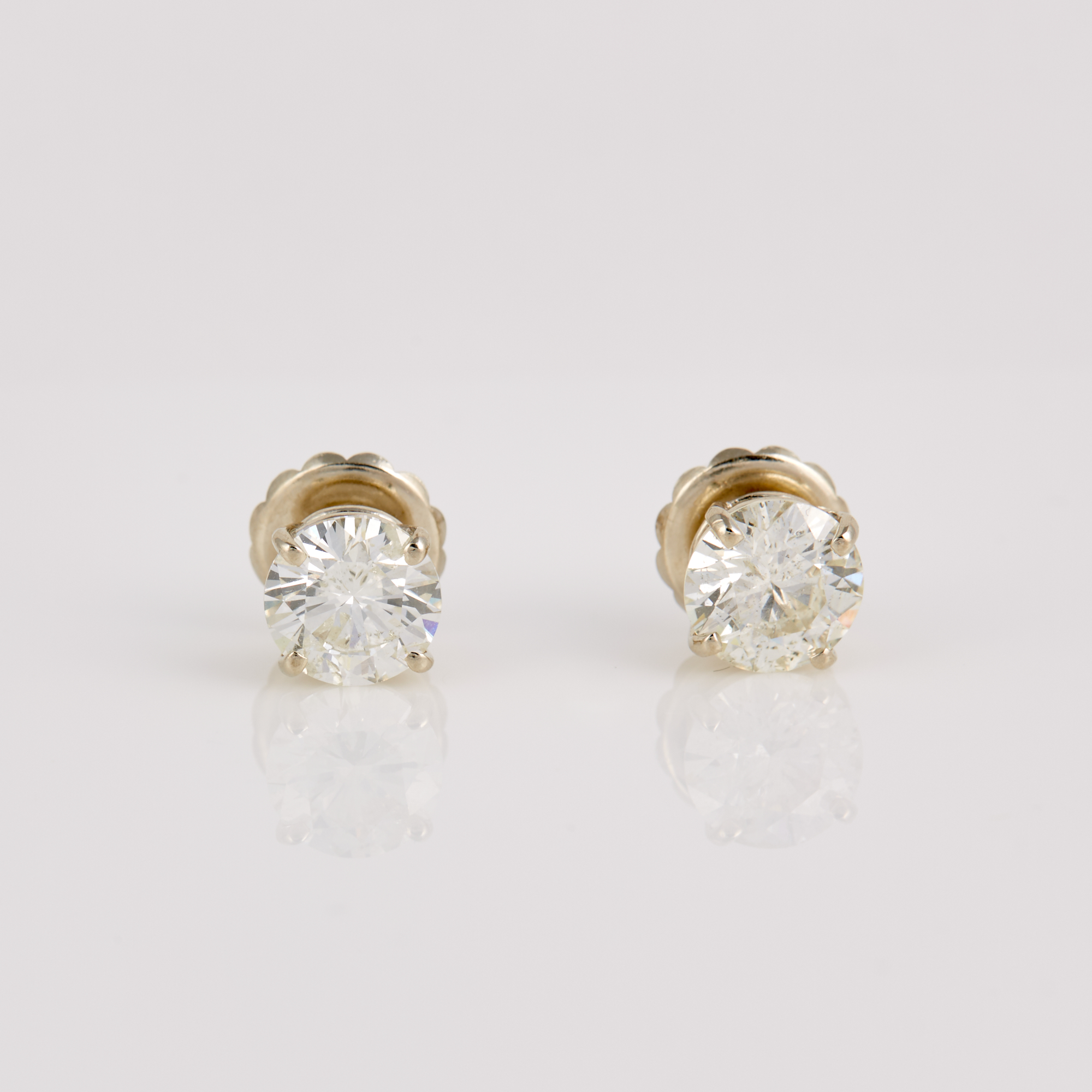 Lot image - Two Diamond Solitaire Earrings about 4.40 cts., 14K 1 dwt., clarity enhanced