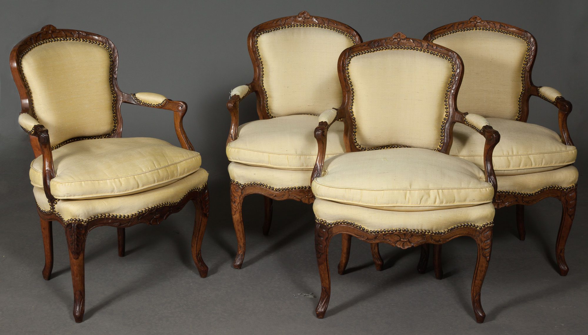 Lot image - Set of Four Louis XV Walnut Open Armchairs (Fauteuils en Cabriolet)