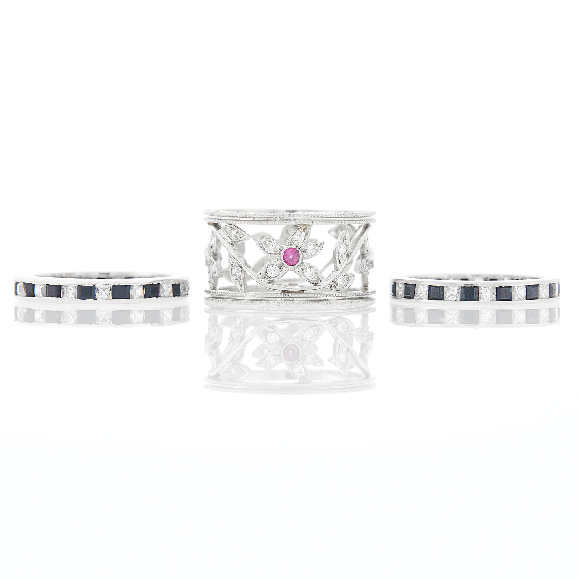 Lot image - Pair of Platinum, Diamond and Sapphire Eternity Bands and Kathy Waterman Wide Platinum, Diamond and Ruby Band Ring