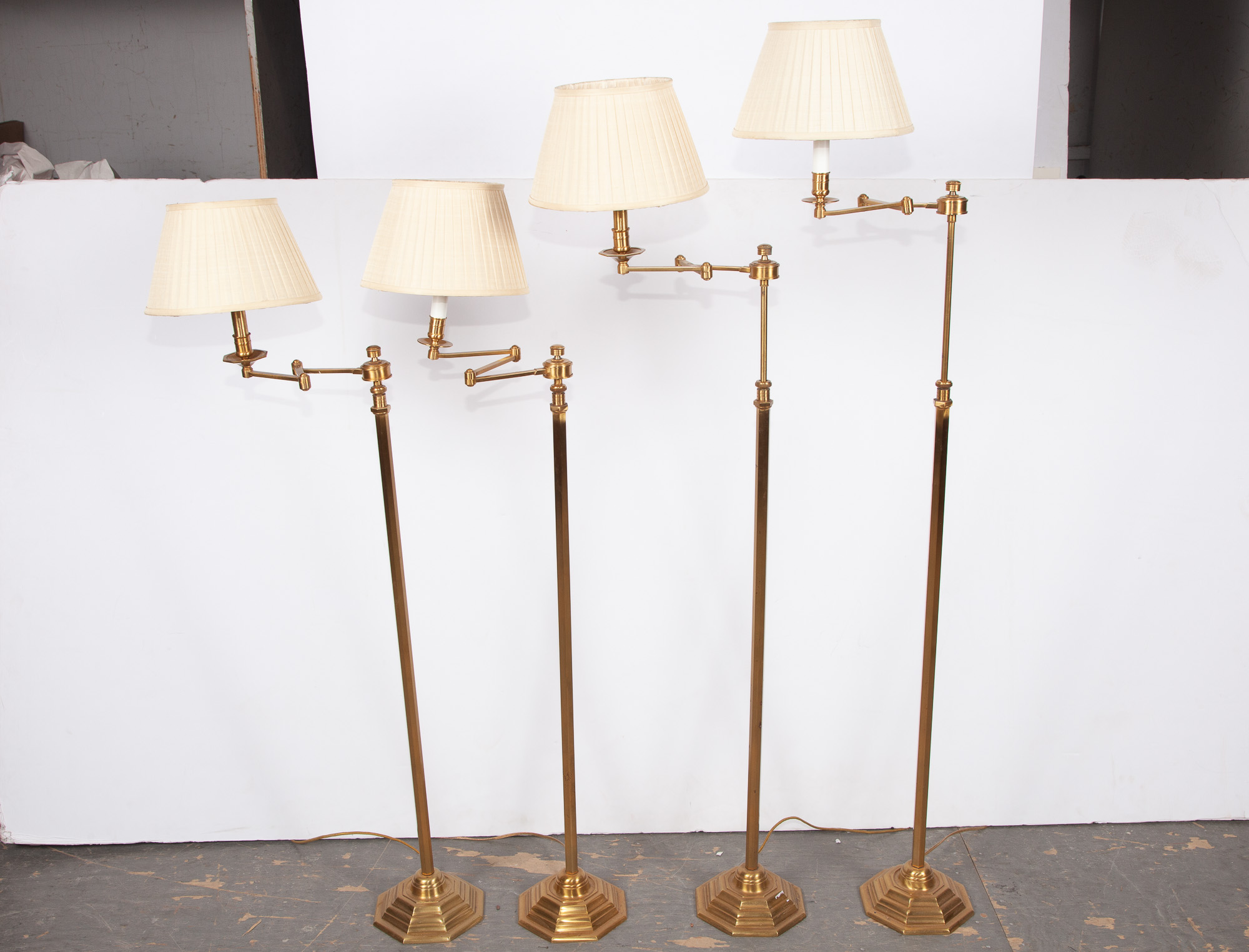 Lot image - Group of Four Brass Swing-Arm Floor Lamps