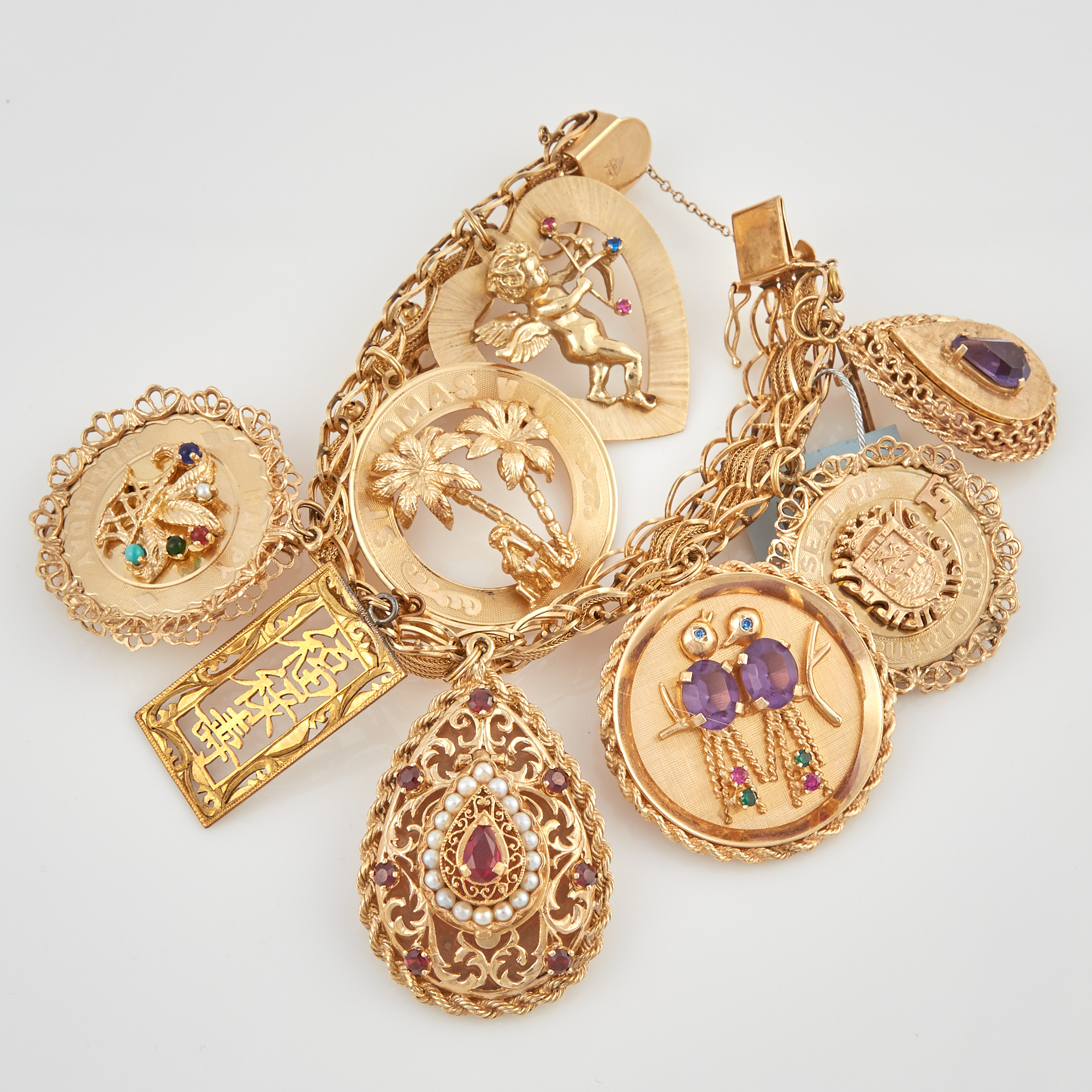 Lot image - Gold Charm Bracelet with 10 gold, bead and stone charms attached, 14K and 10K 74 dwt. all