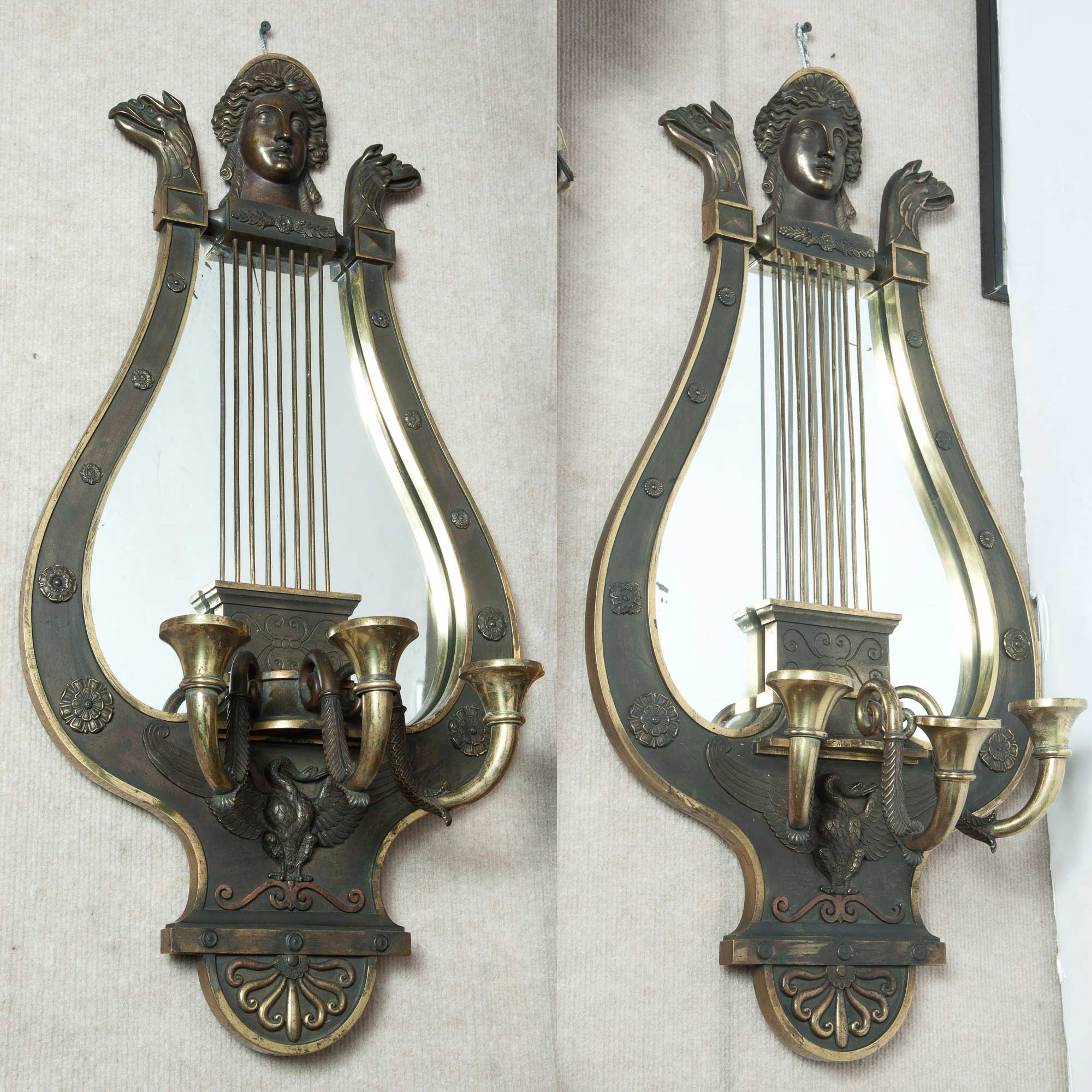 Lot image - Pair of Empire Style Gilt and Patinated Metal Lyre-Form Mirrored Three-Light Wall Lights