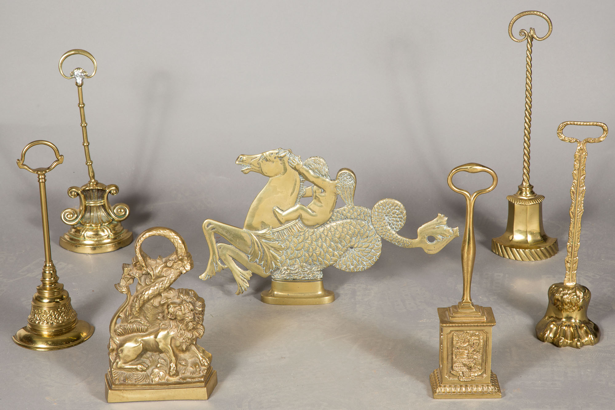 Lot image - Group of Six English Brass Doorstops