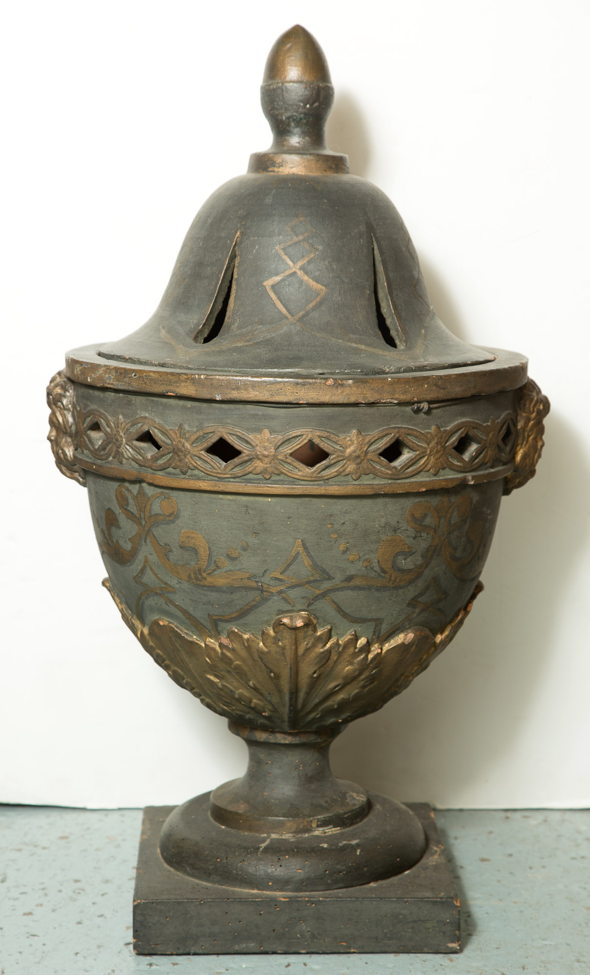 Lot image - Continental Painted and Parcel-Gilt Terracotta Urn on Wood Base