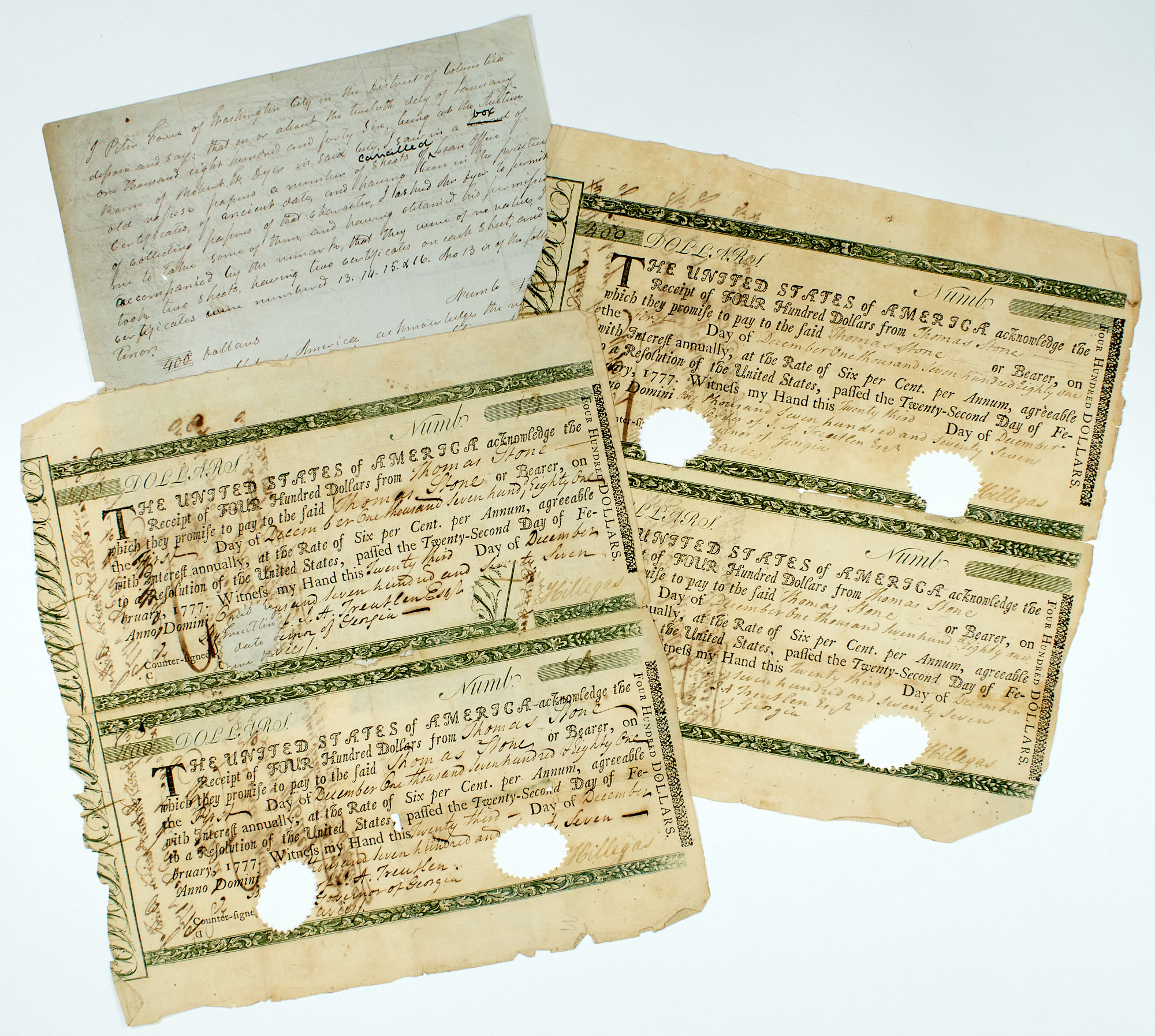 Lot image - [AMERICAN REVOLUTION--FORCE, PETER]  Four rare 1777 United States Loan Receipts with a manuscript note describing them by Peter Force.