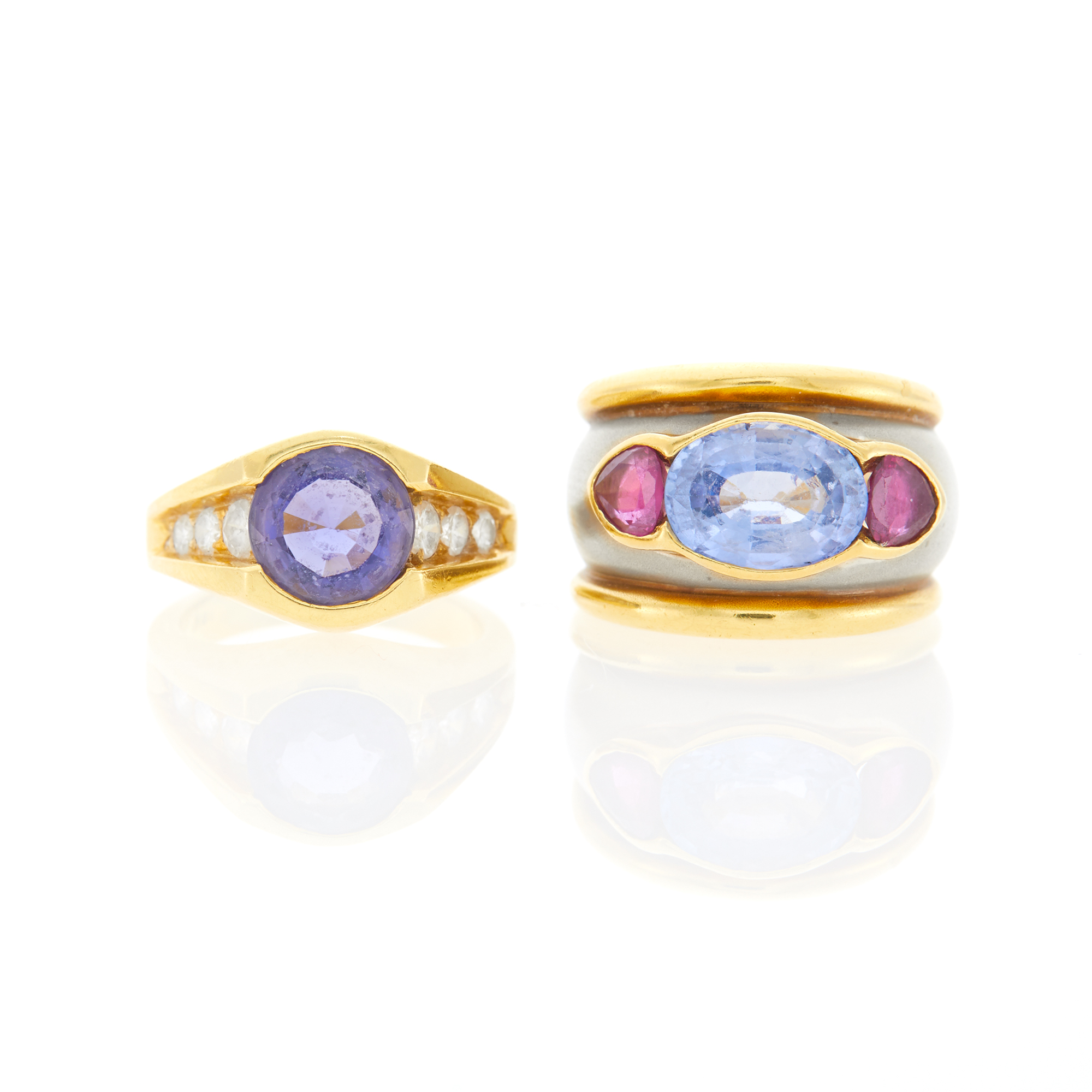 Lot image - Wide Two-Color Gold, Sapphire and Ruby Ring and Gold, Tanzanite and Diamond Ring