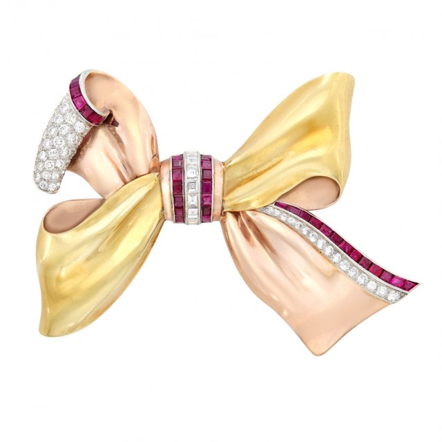 Two-Color Gold, Platinum, Diamond and Ruby Bow Brooch, Attributed to Paul Flato, circa 1940. Sold for $9,375.