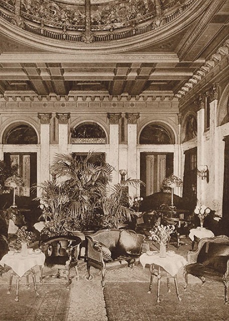 Interior view of the Hotel Manhattan’s Palm Court, or Tea Room, circa 1917. Two oversize Tiffany table lamps are seen on the tables at the rear.