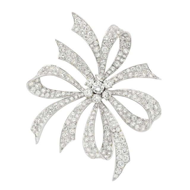 Platinum and Diamond Bow Clip-Brooch, Van Cleef and Arpels. Sold for $31,250.