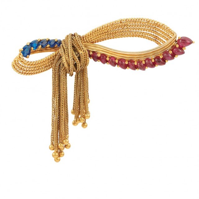 Gold, Cabochon Ruby and Sapphire Bow Fringe Clip-Brooch, Marchak. Sold for $4,375.